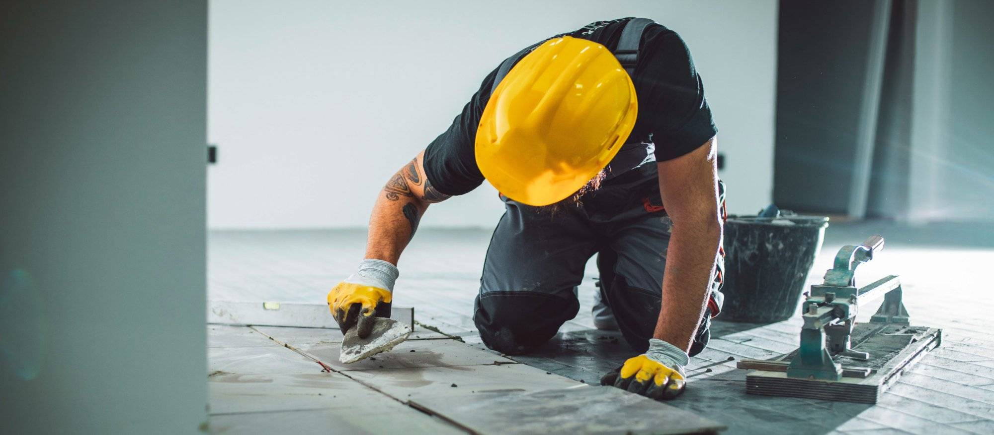 Master installer laying tile